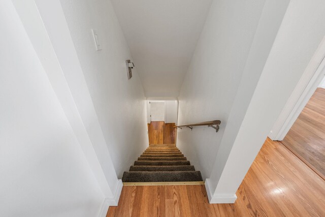 stairs with baseboards and wood finished floors