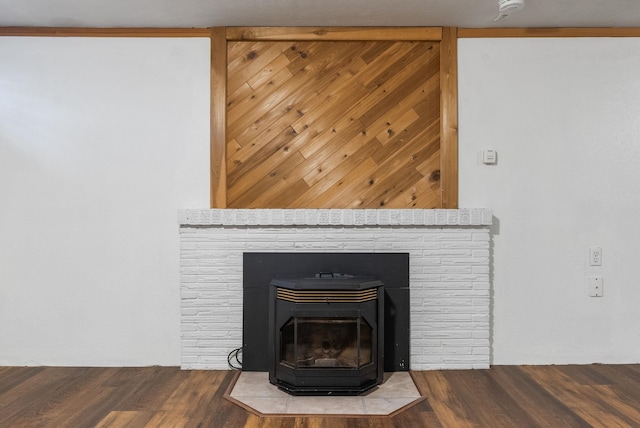 room details featuring wood finished floors and a wood stove
