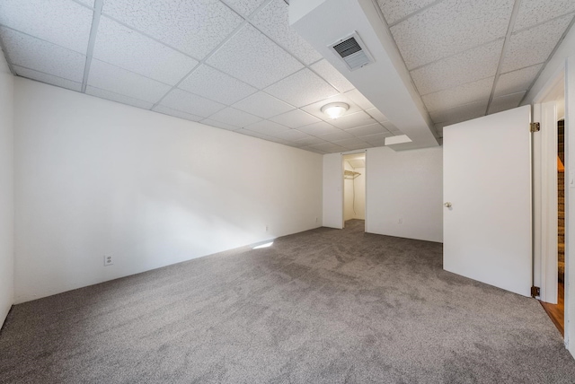 interior space featuring visible vents, carpet flooring, and a drop ceiling