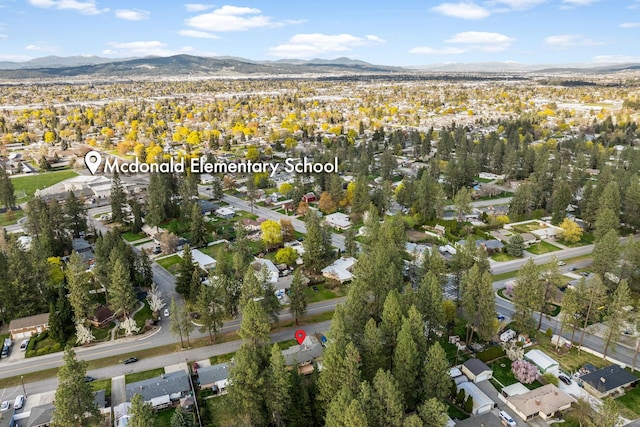 drone / aerial view featuring a residential view and a mountain view