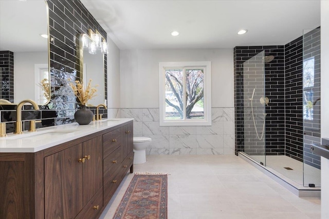 bathroom with a tile shower, tile walls, and a sink