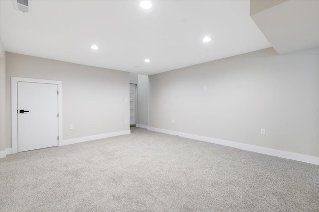 unfurnished room featuring recessed lighting, visible vents, baseboards, and light carpet