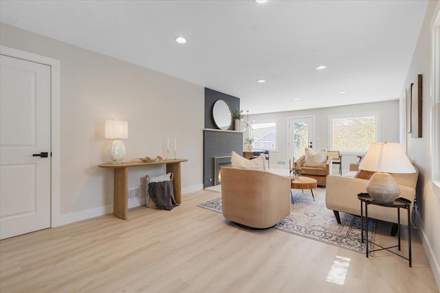 living room with baseboards, wood finished floors, and recessed lighting