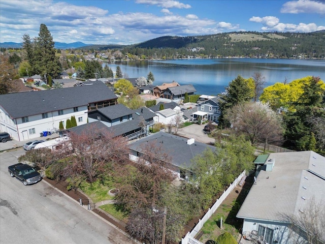 aerial view featuring a water and mountain view and a residential view