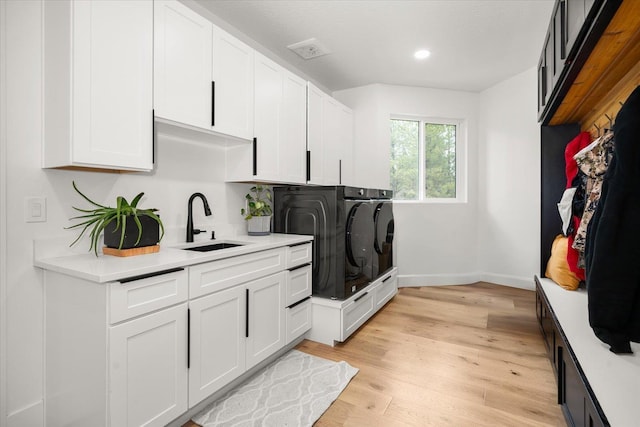 27603 N Bruce Rd, Chattaroy, WA 99003 - washroom featuring a sink, light wood-type flooring, cabinet space, baseboards, and recessed lighting