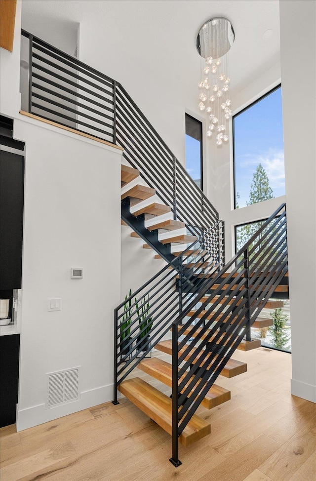 27603 N Bruce Rd, Chattaroy, WA 99003 - staircase with wood finished floors, visible vents, and a high ceiling