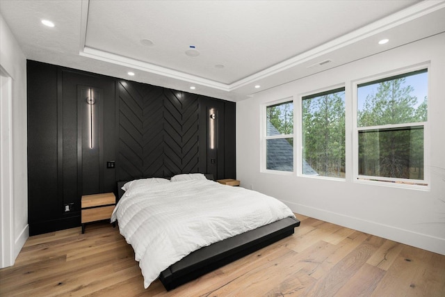 27603 N Bruce Rd, Chattaroy, WA 99003 - bedroom with recessed lighting, baseboards, light wood-style flooring, and a raised ceiling