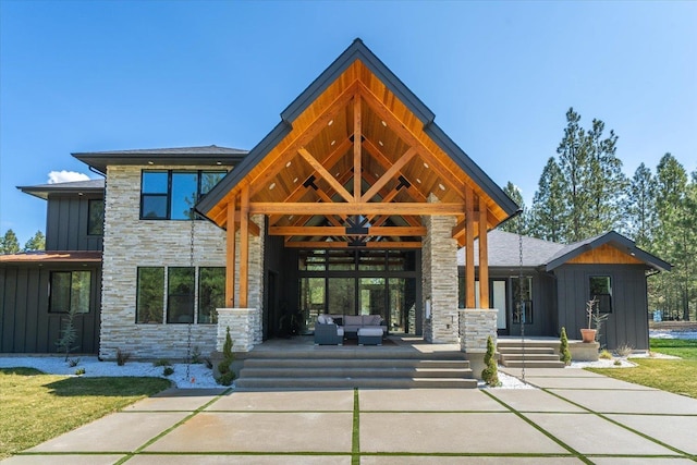 27603 N Bruce Rd, Chattaroy, WA 99003 - view of front of property featuring stone siding, board and batten siding, and an outdoor hangout area