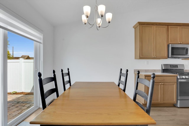 dining area featuring light wood-style flooring and a chandelier