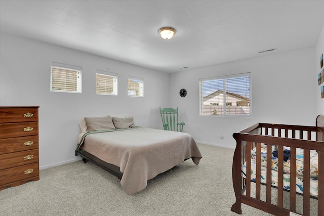 bedroom featuring baseboards, visible vents, and carpet