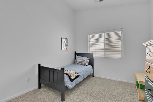 carpeted bedroom featuring visible vents and baseboards