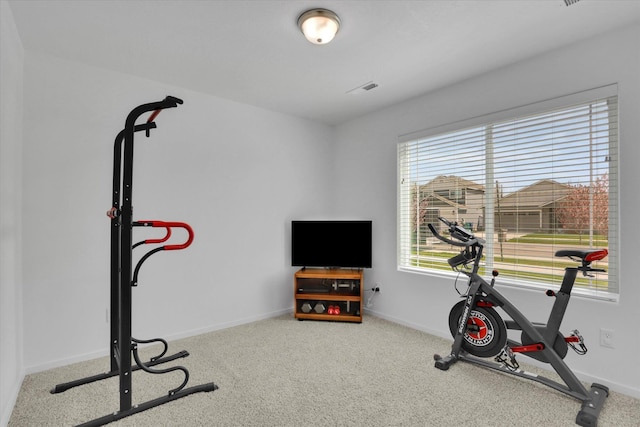 exercise room with visible vents, carpet flooring, and baseboards