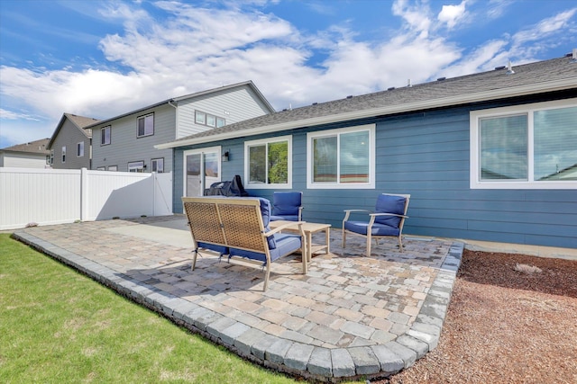 rear view of house featuring fence and a patio area