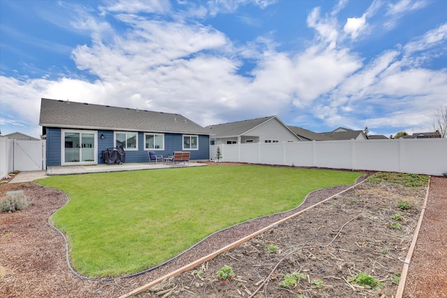 back of property with a fenced backyard, a gate, a patio, and a lawn