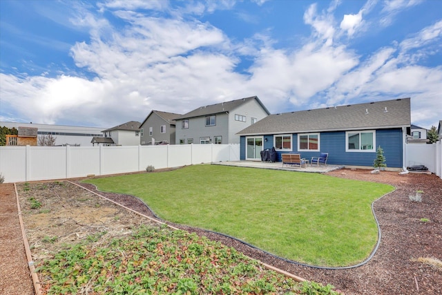 rear view of property featuring a patio area, a fenced backyard, and a yard