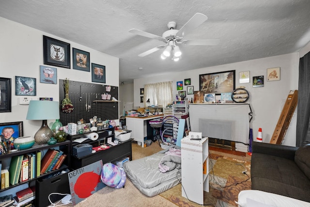 office area featuring a ceiling fan and a textured ceiling