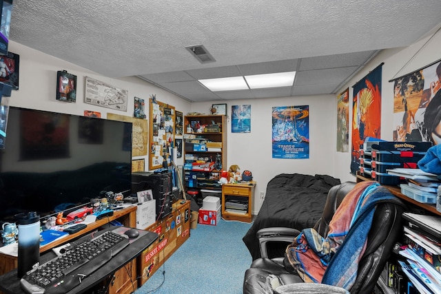 living area featuring carpet floors, visible vents, and a paneled ceiling