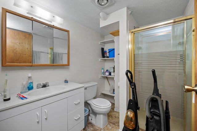 bathroom with vanity, a stall shower, toilet, and a textured ceiling