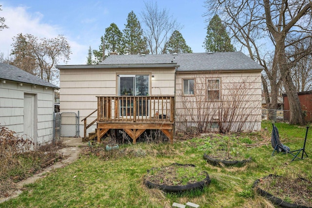 rear view of property featuring fence and a deck