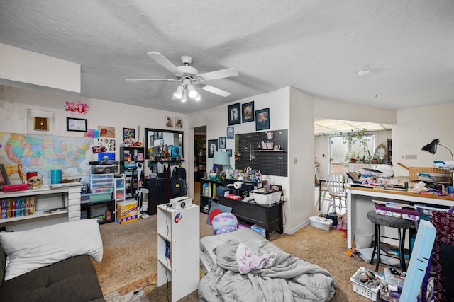 home office featuring carpet flooring, a textured ceiling, and a ceiling fan