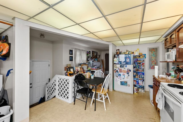 dining area with a paneled ceiling