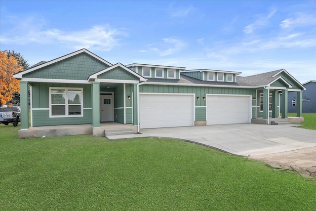 view of front of home featuring board and batten siding, covered porch, a garage, a front yard, and concrete driveway