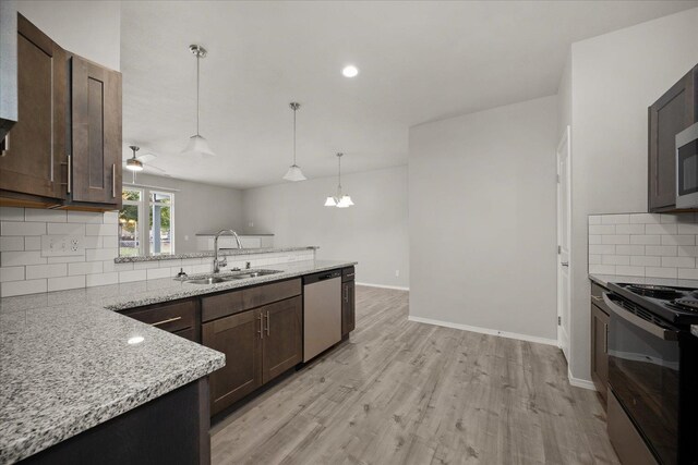 kitchen featuring a sink, black range with electric stovetop, dark brown cabinetry, a peninsula, and stainless steel dishwasher