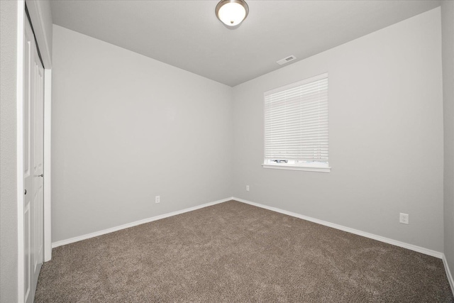 unfurnished bedroom featuring visible vents, baseboards, carpet flooring, and a closet