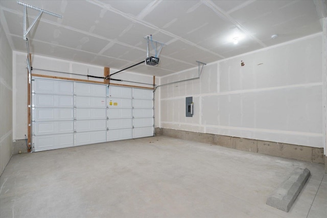 garage with a garage door opener and electric panel