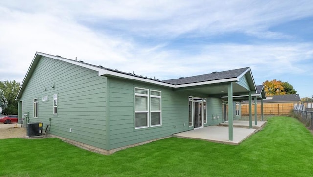 rear view of property with a lawn, fence, and a patio area