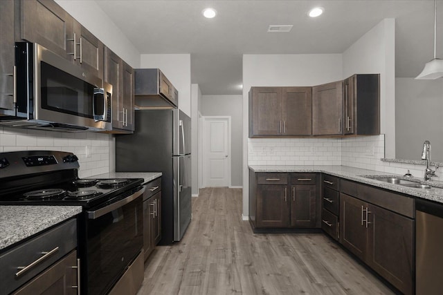 kitchen featuring a sink, dark brown cabinets, and appliances with stainless steel finishes
