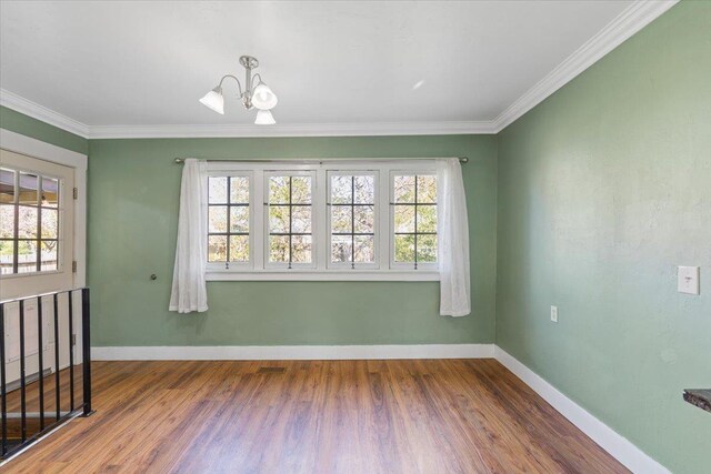 interior space featuring baseboards, wood finished floors, and a chandelier