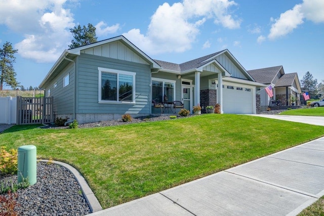 view of front of house with concrete driveway, a front lawn, board and batten siding, and an attached garage