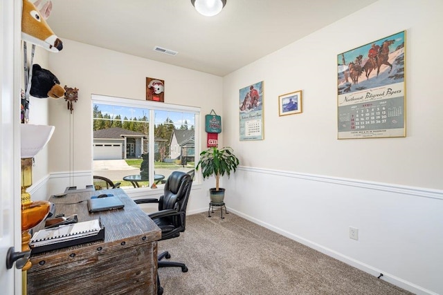 carpeted office space with visible vents and baseboards