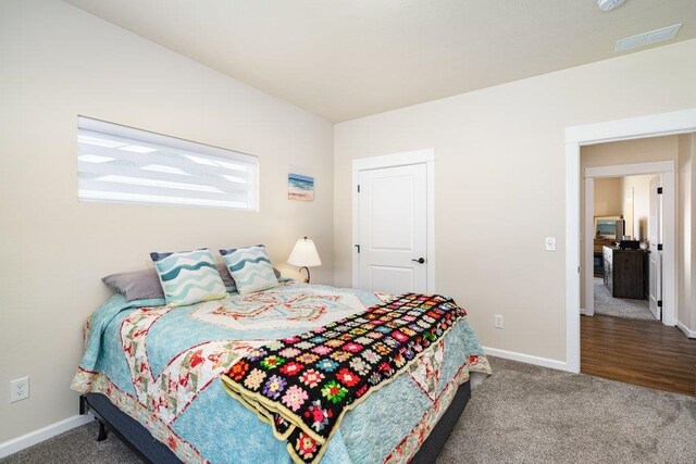 bedroom featuring visible vents, carpet floors, and baseboards