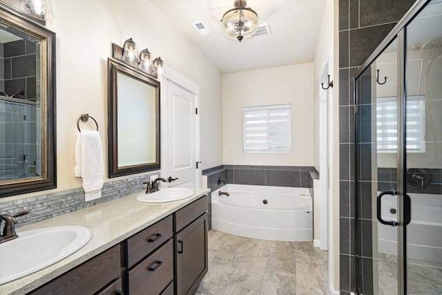 bathroom featuring a bath, a sink, a shower stall, and visible vents