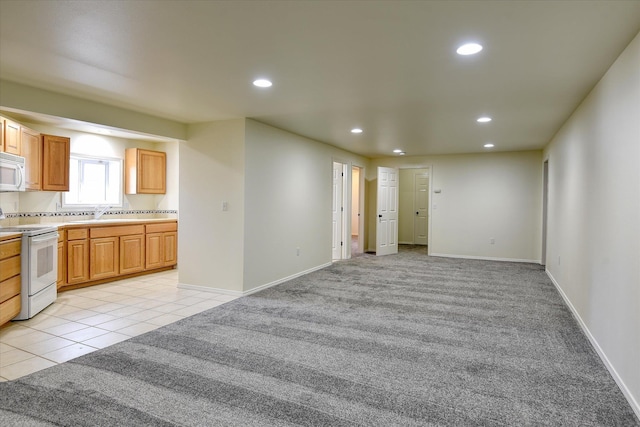 kitchen with open shelves, a sink, light tile patterned floors, tile counters, and white appliances