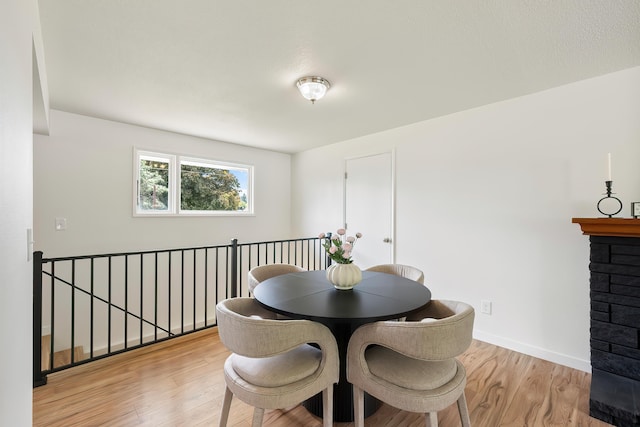 11904 E 22nd Ave, Spokane Valley, WA 99206 - dining space featuring light wood finished floors, a fireplace, and baseboards