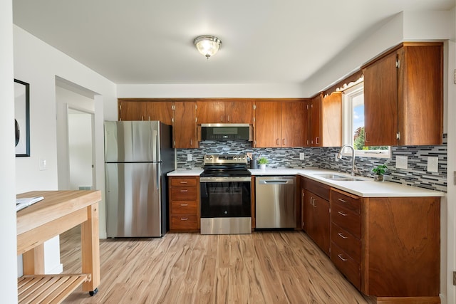 11904 E 22nd Ave, Spokane Valley, WA 99206 - kitchen featuring appliances with stainless steel finishes, a sink, light wood-style floors, and light countertops