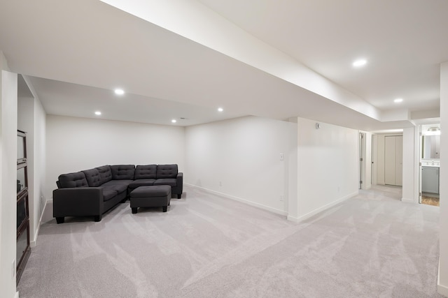 living room featuring recessed lighting, light colored carpet, and baseboards