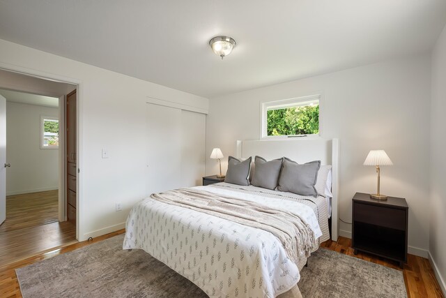 11904 E 22nd Ave, Spokane Valley, WA 99206 - bedroom with multiple windows, a closet, wood finished floors, and baseboards