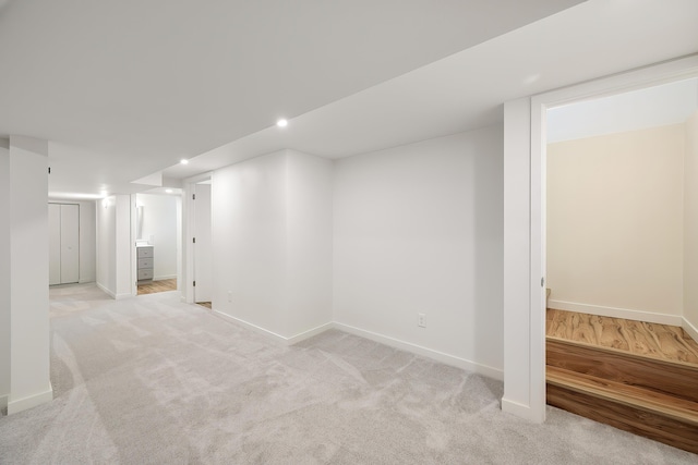 finished basement with light colored carpet, recessed lighting, and baseboards