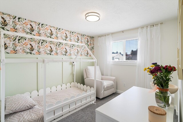 carpeted bedroom featuring a textured ceiling
