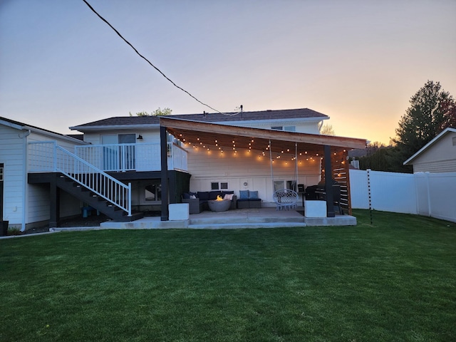 back of property with a patio, a wooden deck, an outdoor living space, stairway, and fence private yard