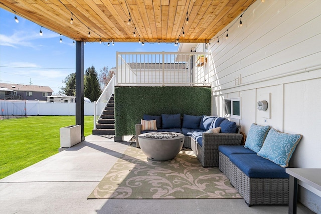 view of patio featuring outdoor lounge area, stairs, and fence
