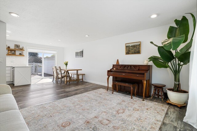 sitting room with baseboards, recessed lighting, and wood finished floors