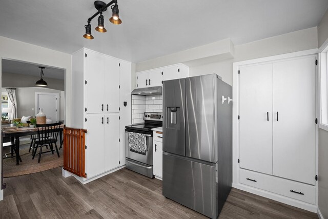 kitchen with white cabinetry, stainless steel appliances, under cabinet range hood, backsplash, and dark wood-style floors