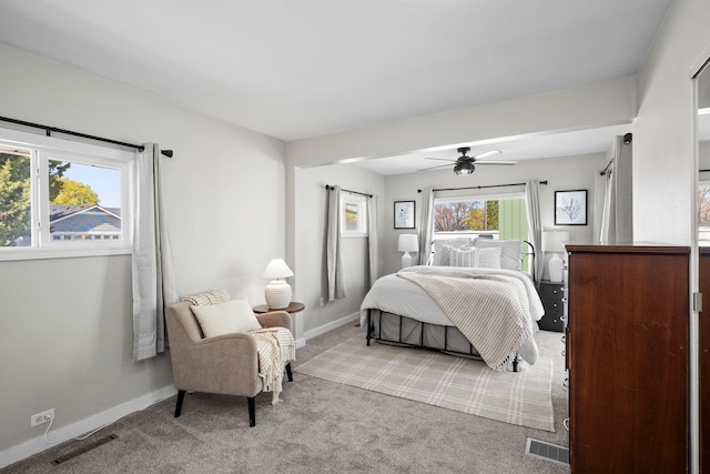 carpeted bedroom featuring baseboards, visible vents, and ceiling fan