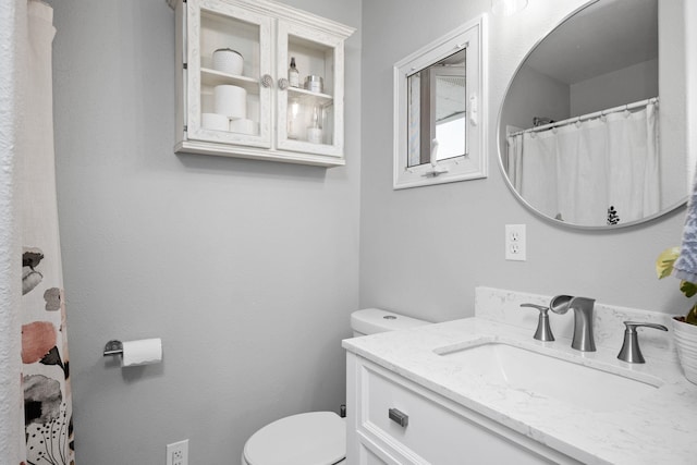 bathroom featuring toilet and vanity
