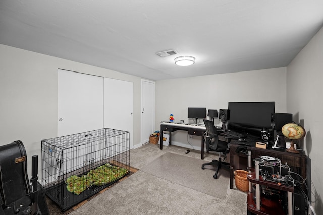office featuring carpet, visible vents, and baseboards